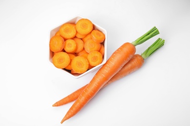 Photo of Ripe fresh carrots on white background