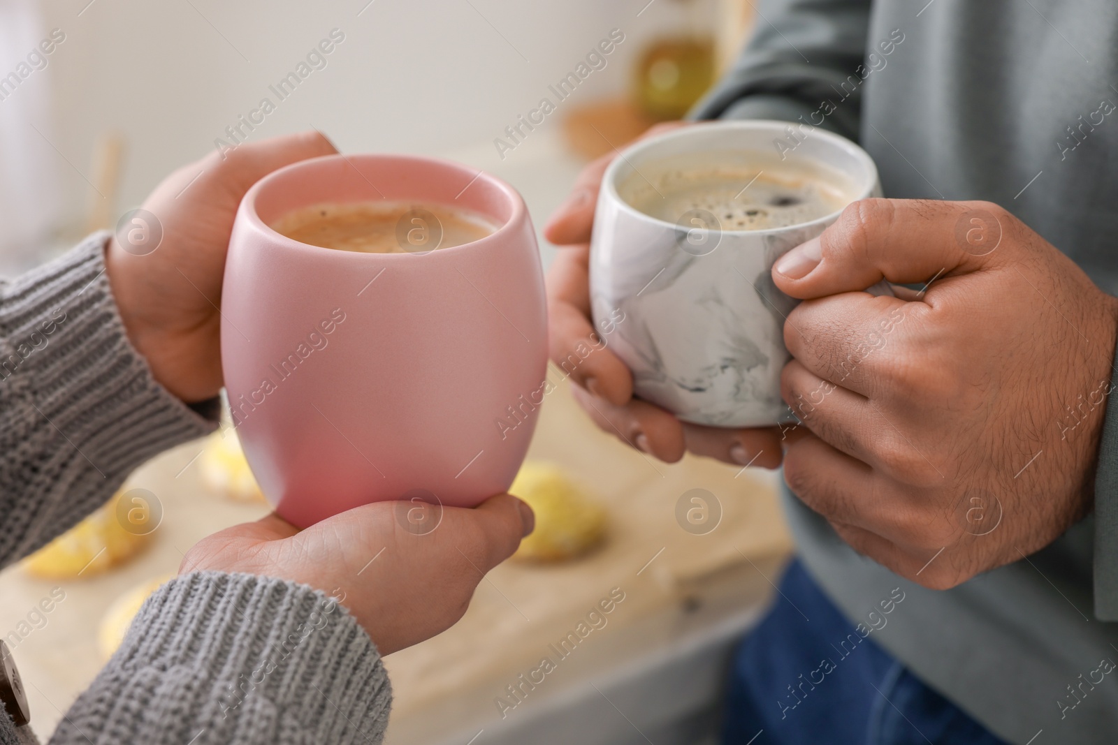 Photo of Couple drinking coffee at home, closeup view