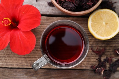 Photo of Flat lay composition with delicious hibiscus tea on wooden table