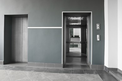 Photo of Stylish elevator with open and close doors