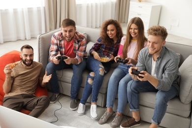 Emotional friends playing video games at home