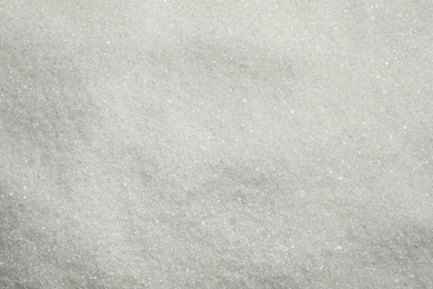 Photo of Pile of granulated sugar as background, top view