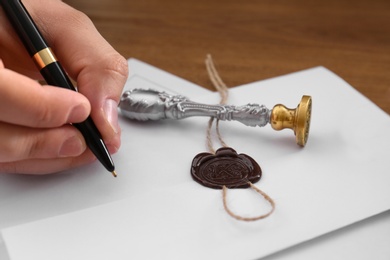 Male notary working with documents at table, closeup