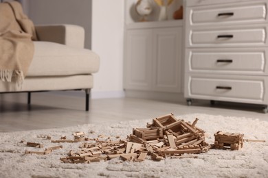 Photo of Wooden construction set on carpet indoors. Children's toy