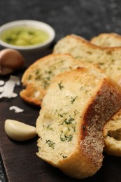 Photo of Tasty baguette with garlic and dill on table, closeup