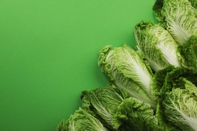 Fresh ripe Chinese cabbages on light green background, flat lay. Space for text