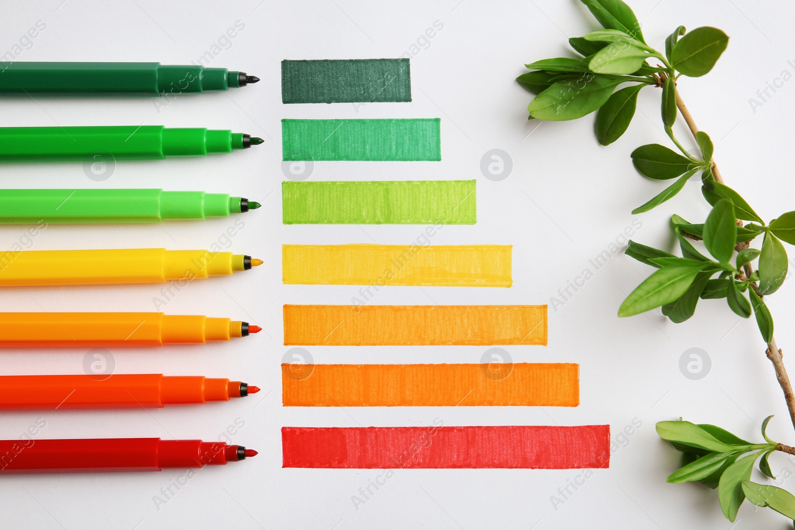 Photo of Flat lay composition with colorful markers on white background. Energy efficiency concept