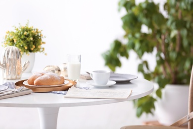 Photo of Tasty breakfast with fresh croissants on table