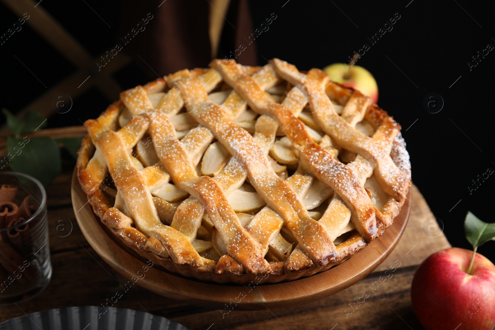 Photo of Delicious traditional apple pie on wooden stand
