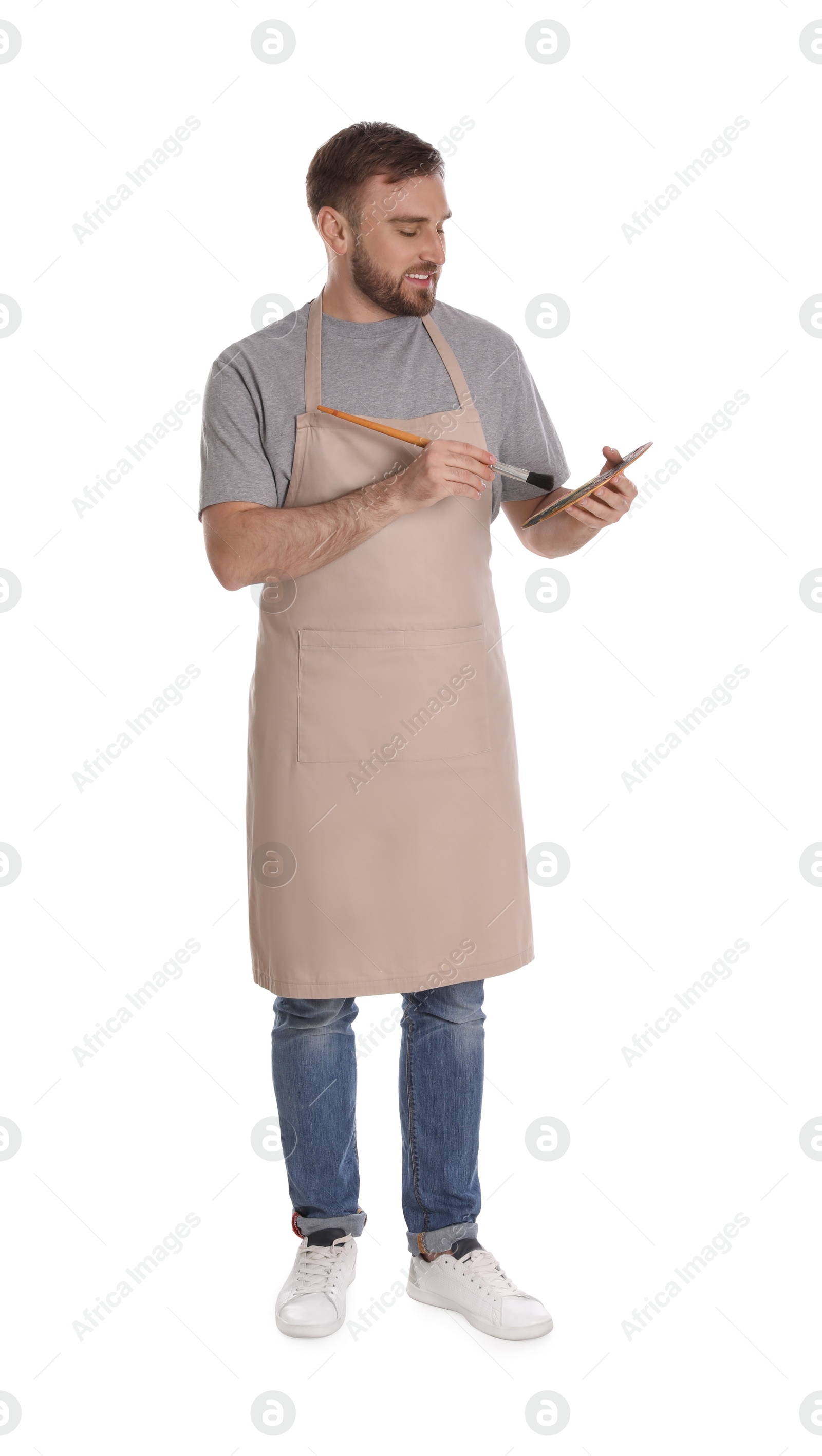 Photo of Man with painting tools on white background. Young artist