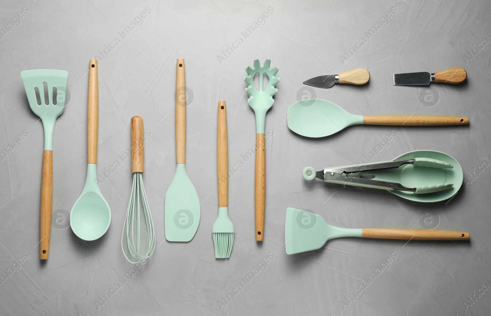 Photo of Set of different kitchen utensils on grey table, flat lay