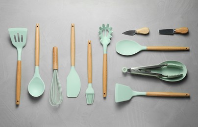 Photo of Set of different kitchen utensils on grey table, flat lay