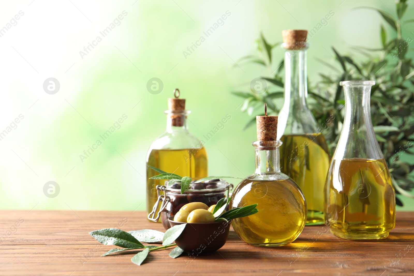 Photo of Composition with fresh olive oil on table