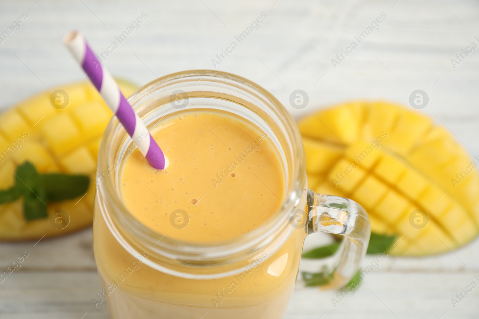 Photo of Fresh delicious mango drink on table, closeup