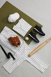 Photo of Flat lay composition with baseball uniform and sports equipment on color background