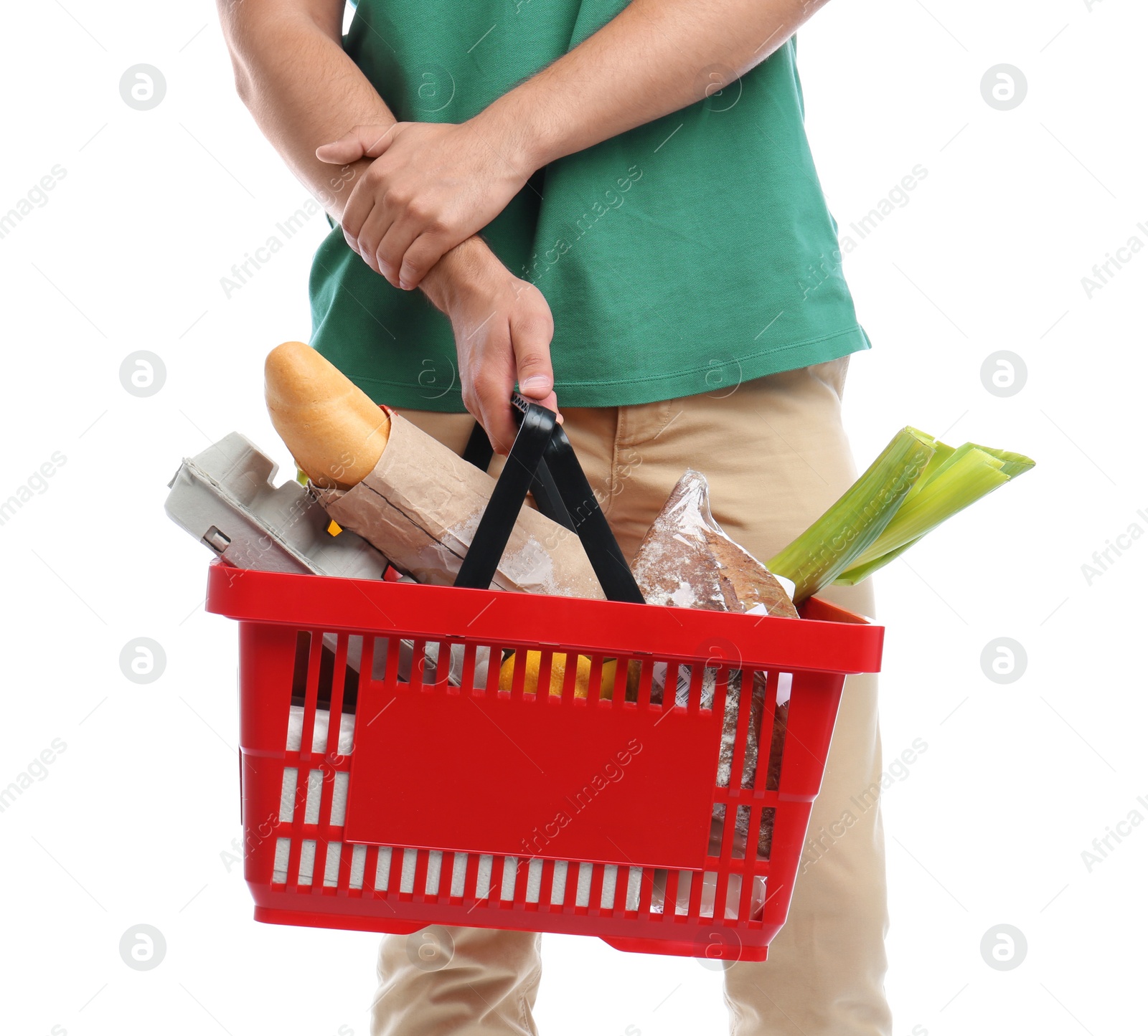 Photo of Young man with shopping basket full of products isolated on white, closeup