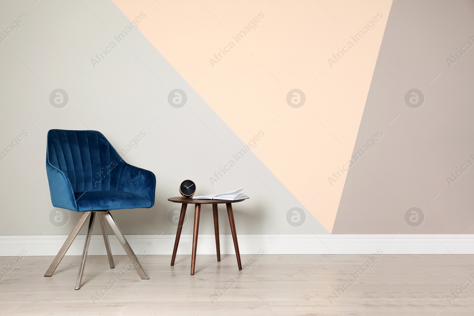 Photo of Modern blue chair and table for interior design on wooden floor at color wall