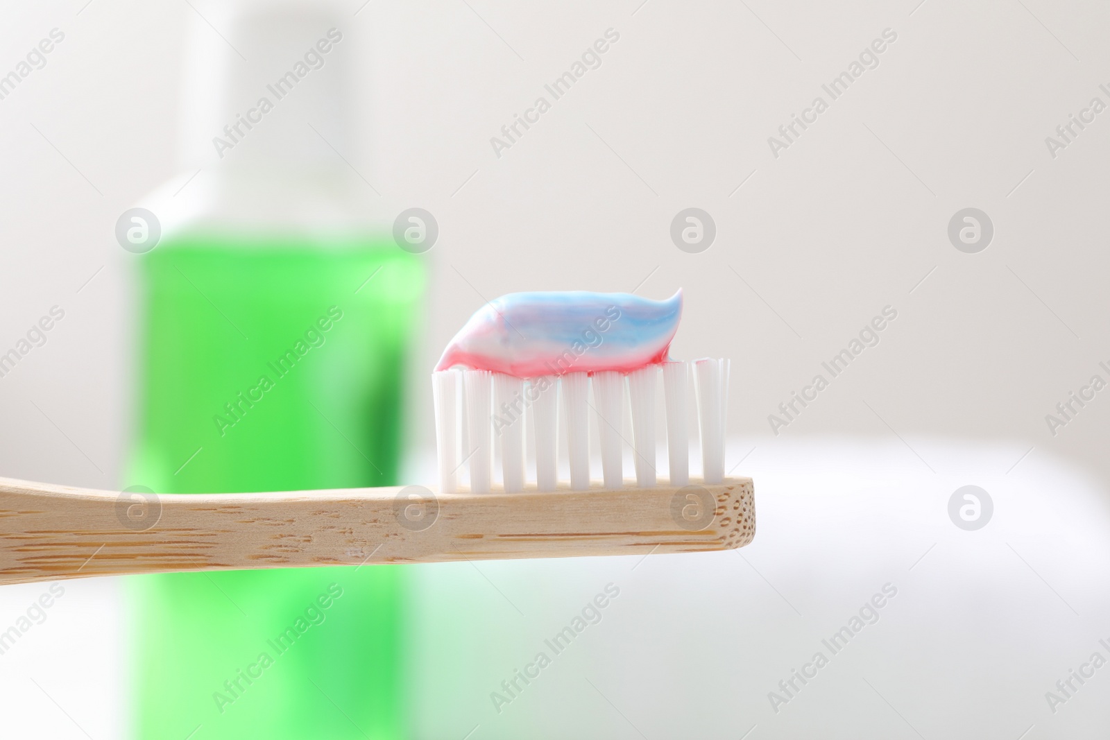 Photo of Toothbrush with paste on blurred background, closeup