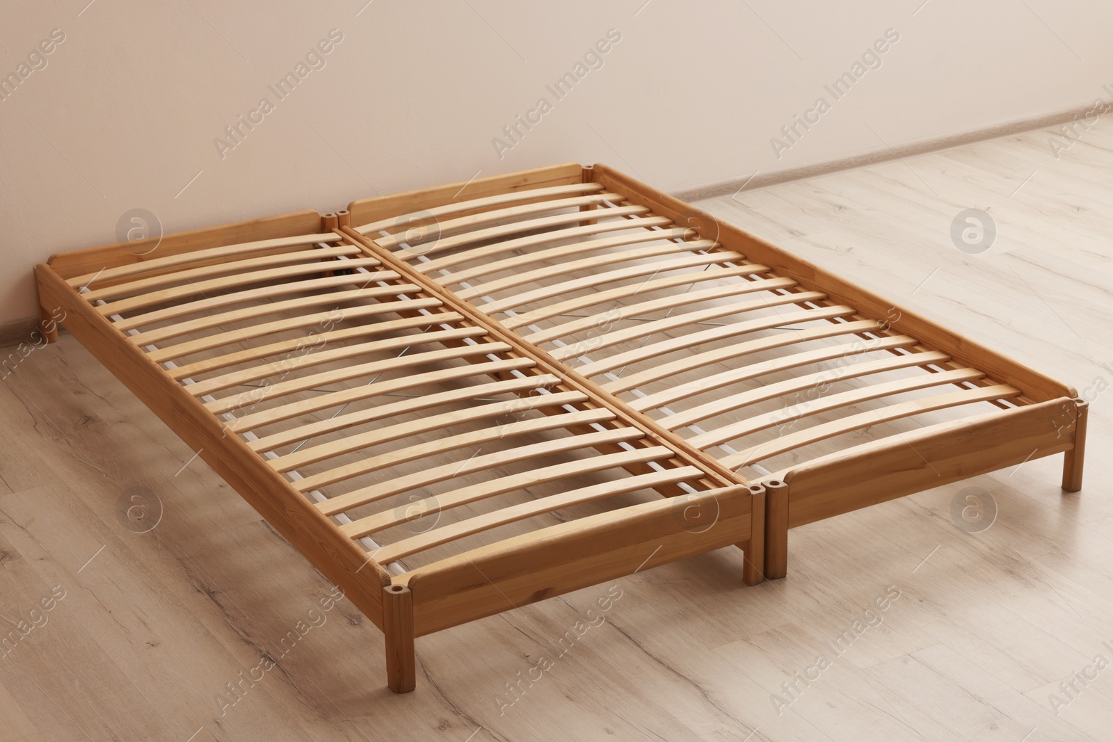 Photo of Wooden bed frame on floor in room