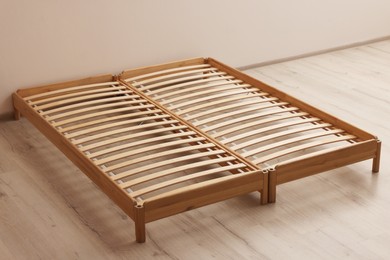 Photo of Wooden bed frame on floor in room