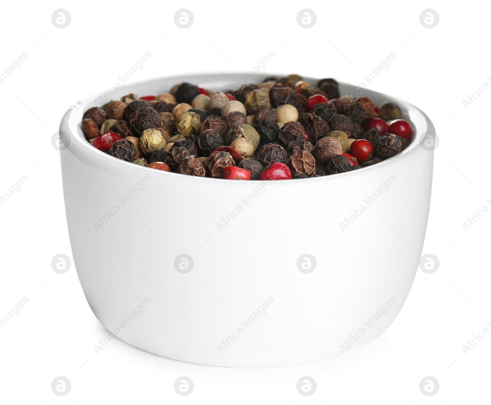 Photo of Bowl of mixed peppercorns isolated on white