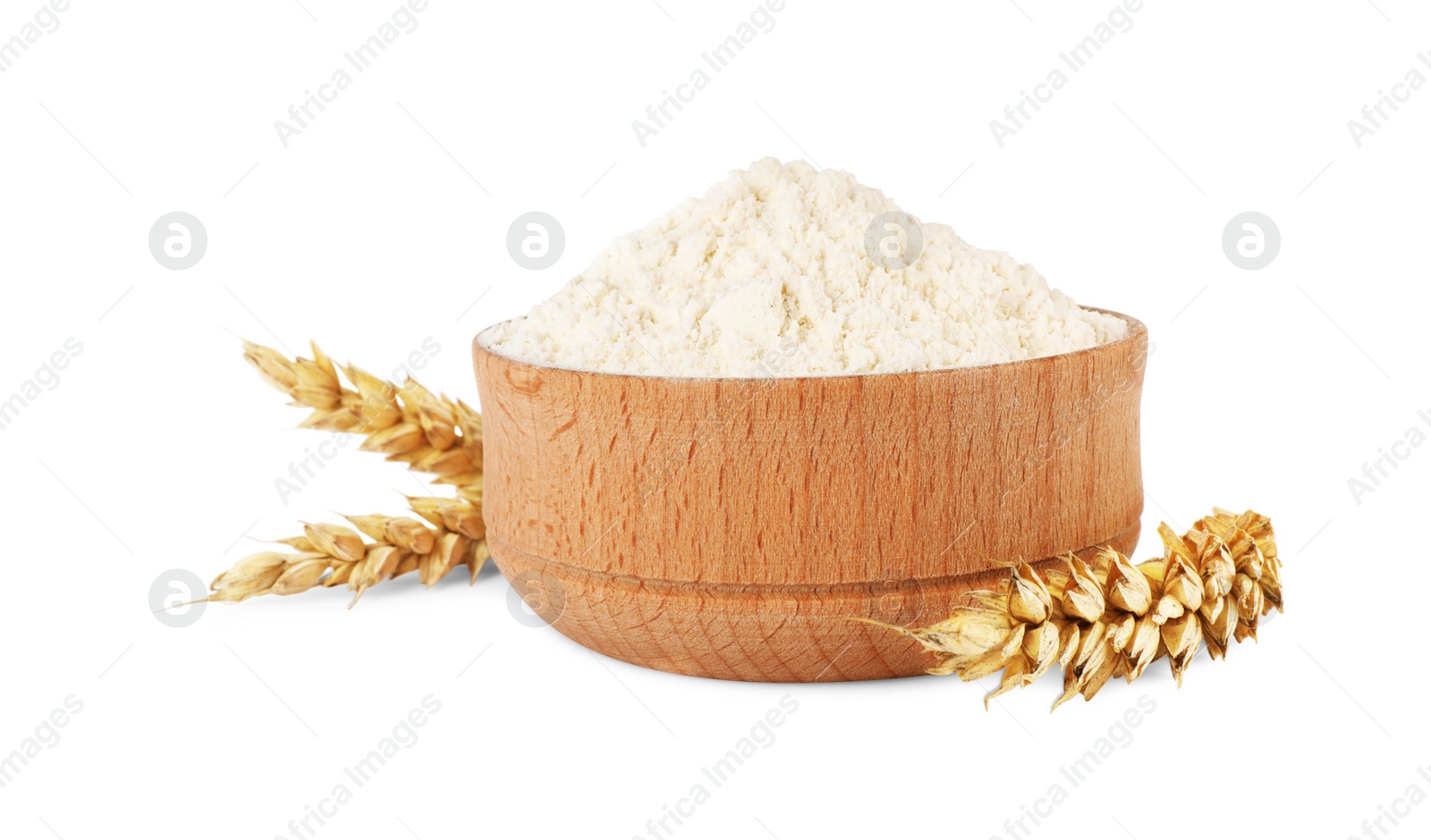 Photo of Wooden bowl of organic wheat flour isolated on white