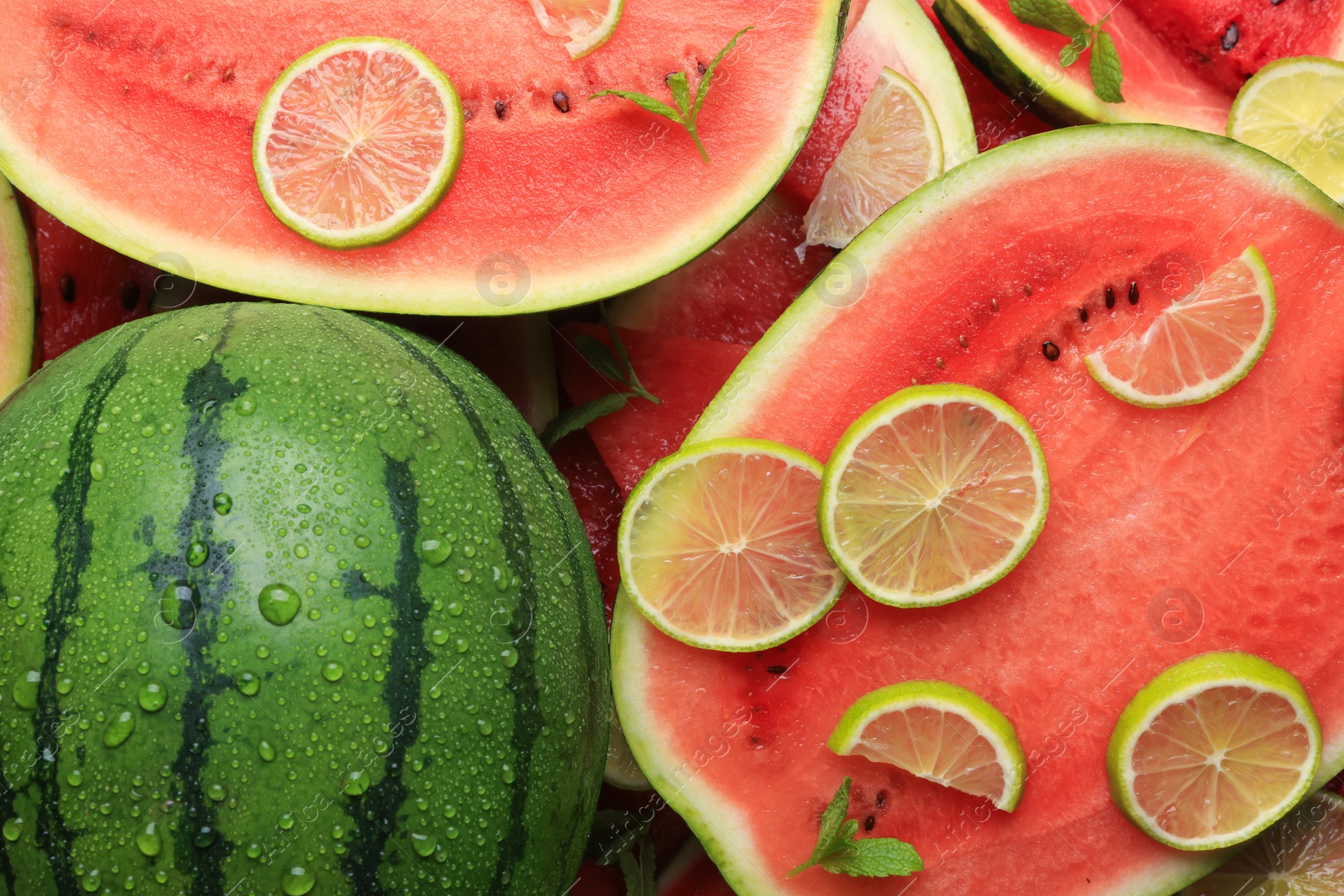 Photo of Juicy watermelon with lime and mint as background, top view