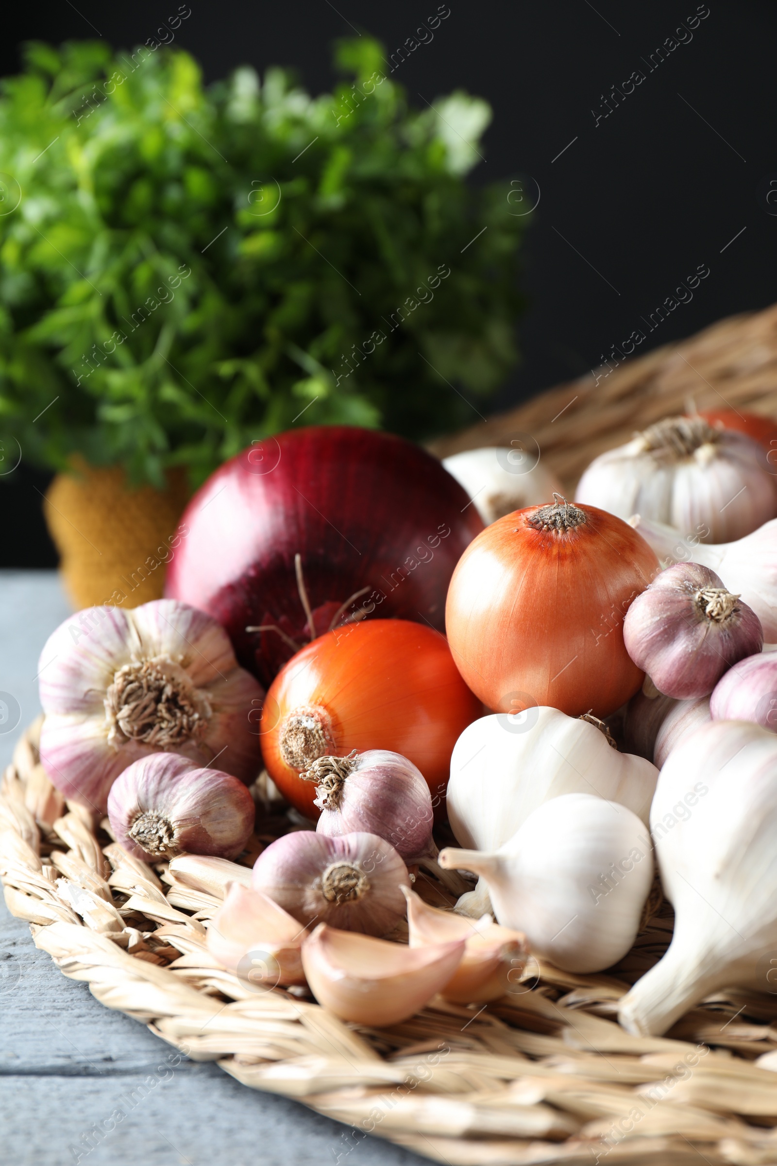 Photo of Fresh raw garlic and onions on table, closeup