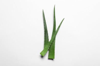 Photo of Green aloe vera leaves on white background, top view