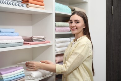 Happy customer choosing bed linens in shop
