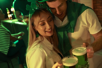 Photo of Couple with beer celebrating St Patrick's day in pub