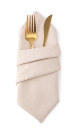 Photo of Beige napkin with golden fork and knife isolated on white, top view. Cutlery set