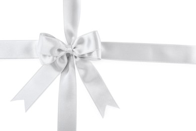 Photo of Silver satin ribbons with bow on white background, top view