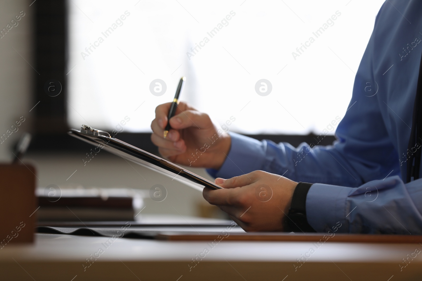 Photo of Male lawyer working at table in office, closeup