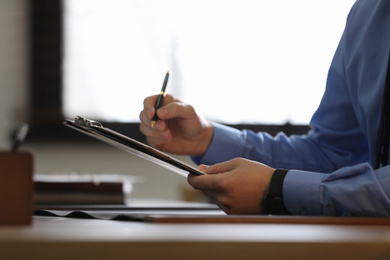 Male lawyer working at table in office, closeup