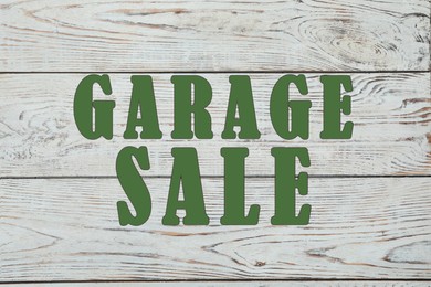 Image of Words Garage Sale on white wooden surface, top view