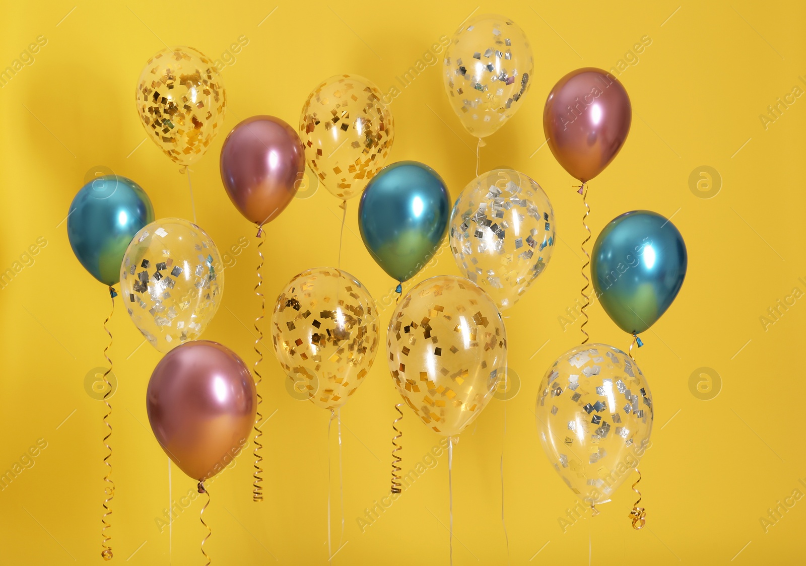 Photo of Bright balloons with ribbons on color background