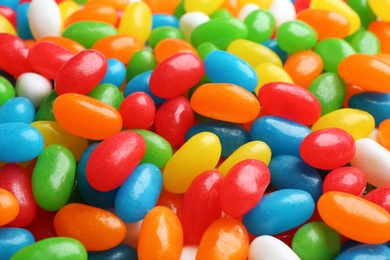 Photo of Tasty colorful jelly beans as background, closeup