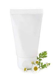 Photo of Tube of hand cream and chamomiles on white background