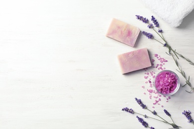 Photo of Flat lay composition with handmade soap bars and space for text on white wooden background