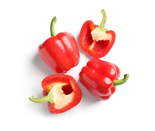 Photo of Cut and whole ripe red bell peppers on white background, top view