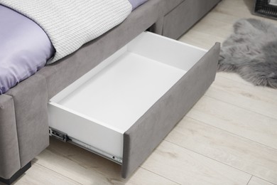 Photo of Storage drawer for bedding under modern bed in room