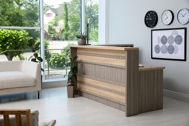 Photo of Lobby interior with stylish wooden receptionist desk