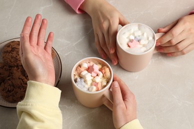 Photo of Women having coffee break at marble table, closeup