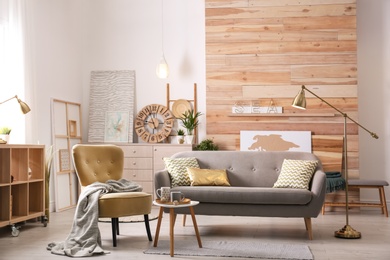 Photo of Stylish living room interior with comfortable sofa. Idea for home decor