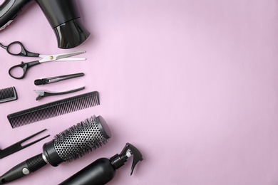 Photo of Flat lay composition with professional hairdresser tools on color background