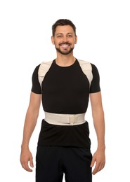 Photo of Handsome man with orthopedic corset on white background