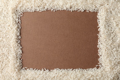 Photo of Frame made with long grain rice on color background, top view. Space for text