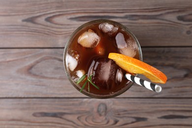 Tasty refreshing drink with coffee and orange juice on wooden table, top view