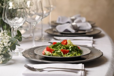 Photo of Delicious salad served on table in restaurant